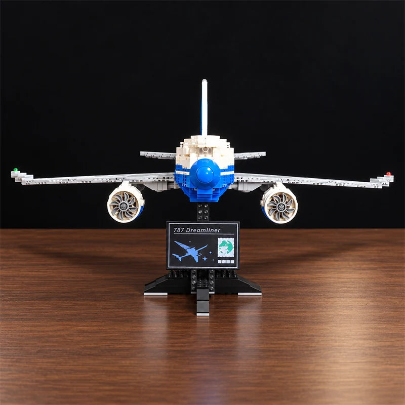 Front view of a Boeing 787 Dreamliner building blocks airplane model featuring detailed jet engines, blue and white livery, and a display stand.