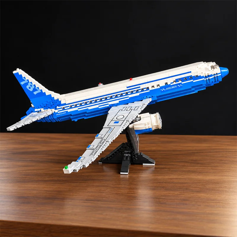 Front view of a Boeing 787 Dreamliner building blocks airplane model featuring detailed jet engines, blue and white livery, and a display stand.