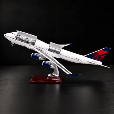 Delta Boeing 747 1:150 scale model airplane with open cabin interior and white LED lighting on a display stand.